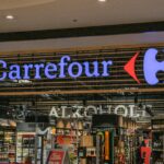 Vibrant Carrefour storefront with neon signage displaying in a retail environment.