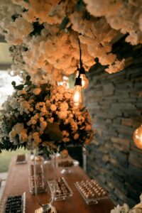 A beautifully decorated table with flowers and warm lighting perfect for events.